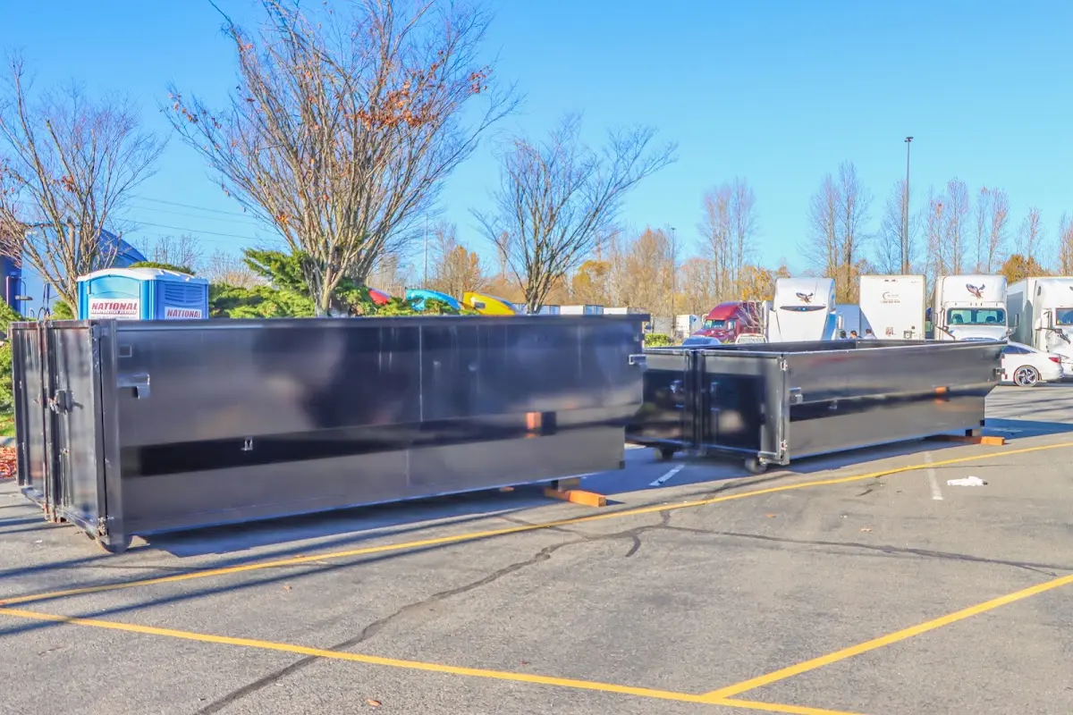 Professional dumpster rental service with roll-off container on residential driveway in Collinsville